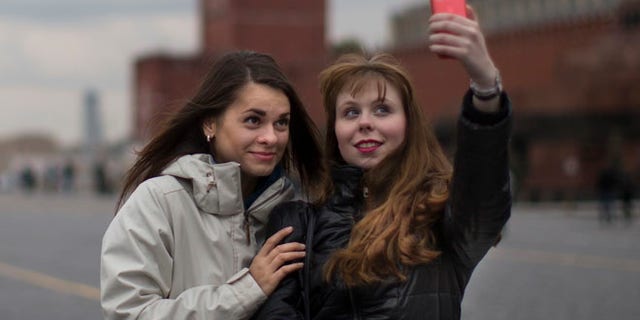 "Safe selfie" instructions warn against standing on railroad tracks, climbing onto roofs or posing with a gun or a tiger.