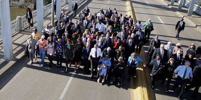 March 7, 2015: President Obama, first lady Michelle Obama, Malia and Sasha as well as members of Congress, former President George W. Bush and his wife Laura, and civil rights leaders make a symbolic walk across the Edmund Pettus Bridge in Selma, Ala.