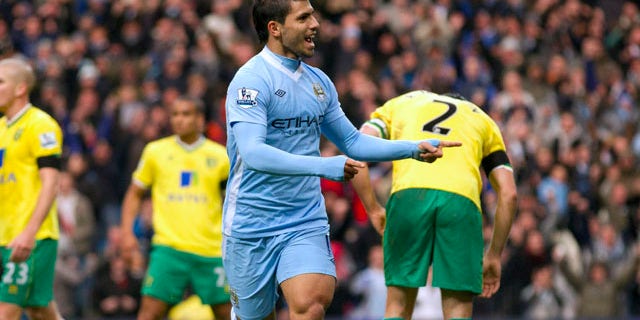 Manchester City's Sergio Aguero, center right, celebrates after scoring against Norwich during their English Premier League soccer match at The Etihad Stadium, Manchester, England, Saturday Dec. 3, 2011. (AP Photo/Jon Super)
