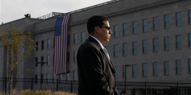 A U.S. Secret Service agent stands watch outside the Pentagon before the start of ceremonies for the 10th commemoration of the Sept. 11 attacks.
