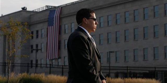 A U.S. Secret Service agent stands watch outside the Pentagon before the start of ceremonies for the 10th commemoration of the Sept. 11 attacks.