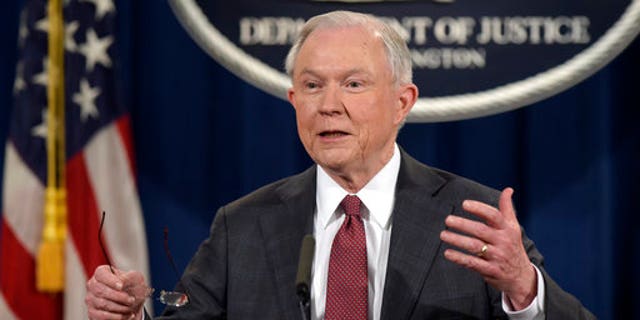 FILE - In this March 2, 2017, file photo, Attorney General Jeff Sessions speaks during a news conference at the Justice Department in Washington. City leaders across the U.S. are vowing to intensify their fight against President Donald Trump's promised crackdown on so-called "sanctuary cities" despite the financial risks. Defiance that filled a New York City gathering of municipal officials from urban centers clashed Monday, March 27, with pointed warnings from the White House's West Wing, where Sessions issued a dire warning to urban leaders. (AP Photo/Susan Walsh, File)