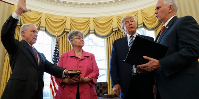 Feb. 9, 2017: President Donald Trump watches as Vice President Mike Pence administers the oath of office to Attorney General Jeff Sessions, accompanied by his wife Mary in the Oval Office of the White House in Washington.