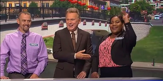 'Wheel of Fortune' host Pat Sajak with contestants