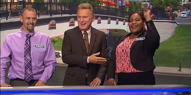Pat Sajak, the leader of Laimės ratas, with the participants of the competition