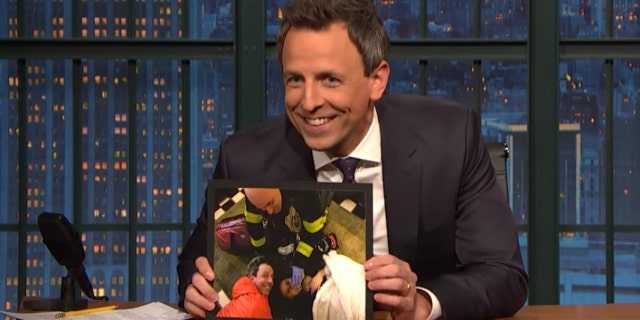 Seth Meyers shows off photos of wife giving birth to their second son in their hotel lobby on Monday's night "Late Night with Seth Meyers."