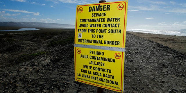 Contaminated water signs are placed along the sand following a rain storm in Imperial Beach, California December 4, 2014. The alert was issued because of a rain-driven influx of sewage-fouled water from the Tijuana River, according to the San Diego County Department of Environmental Health.