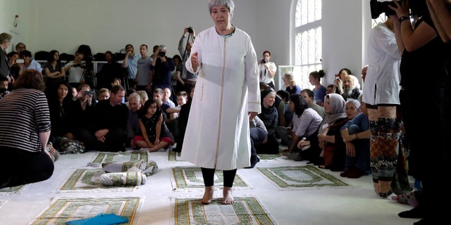 Seyran Ates, standing at center, founder of the Ibn-Rushd-Goethe-Mosque gestures during the opening of the mosque in Berlin, Germany, Friday, June 16, 2017.