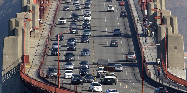 Sept. 19, 2013: Golden Gate Bridge workers shift traffic lanes during the end of the morning commute in San Francisco.