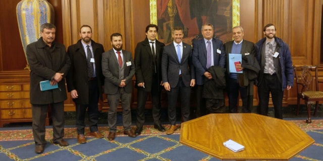 Members of the Free Syrian Army delegation pose with Rep. Adam Kinzinger, R-Ill. (fourth from right)