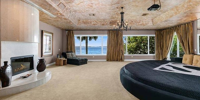 The master bedroom features a round bed frame measuring 15 feet across.