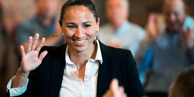 Democrat Sharice Davids waves at her supporters at a Democratic event in Kansas City, Kan., Aug. 8, 2018.