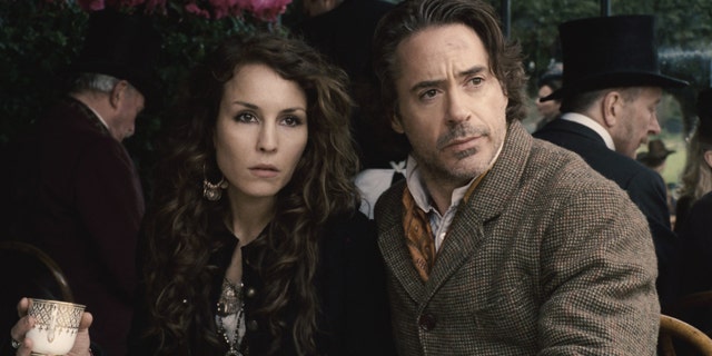 In this film image released by Warner Bros. Pictures, Noomi Rapace, left, and Robert Downey Jr. are shown in a scene from "Sherlock Holmes: A Game of Shadows."