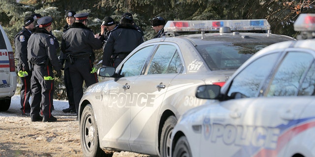 Dec. 16, 2017: Police officers gather while canvassing neighbors for information on the deaths of Barry and Honey Sherman.