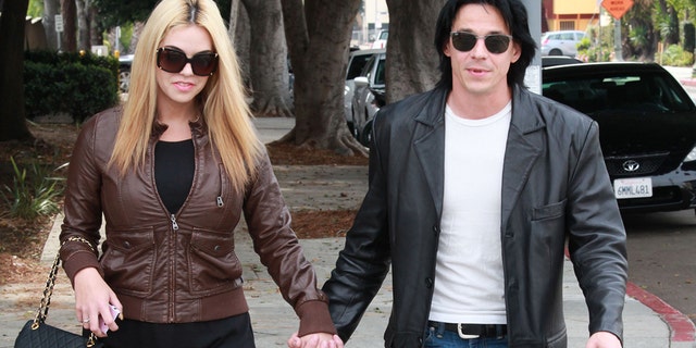 Francis "Coyote" Shivers walks out of Hollywood police station with his wife.