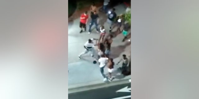 Screen shot from Facebook Live video that captured a shooting early Sunday in Myrtle Beach, S.C., shows man in white t-shirt reaching for a gun.