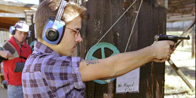 Man performs target practice at a shooting range