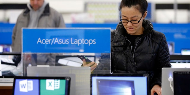Shoppers browse items at Best Buy on Friday.
