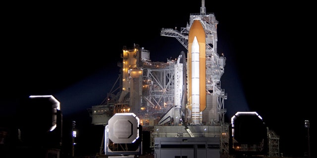 At NASA's Kennedy Space Center in Florida, xenon lights illuminate space shuttle Discovery on Launch Pad 39A following the retraction of the rotating service structure on Nov. 3.