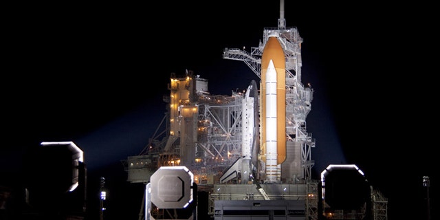 At NASA's Kennedy Space Center in Florida, xenon lights illuminate space shuttle Discovery on Launch Pad 39A following the retraction of the rotating service structure on Nov. 3.