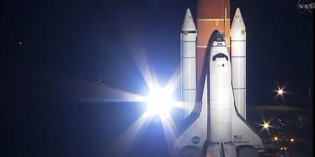 NASA's space shuttle Endeavour heads to the launch pad for its final mission, STS-134, while bathed in bright xenon spotlights on March 10, 2011 at NASA's Kennedy Space Center in Florida. Endeavour will fly its 25th and last mission during the STS-134 flight.