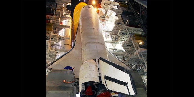 Work platforms inside the Vehicle Assembly Building at NASA's Kennedy Space Center in Florida surround the space shuttle Discovery, its solid rocket boosters and external fuel tank.