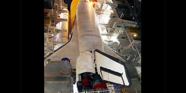 Work platforms inside the Vehicle Assembly Building at NASA's Kennedy Space Center in Florida surround the space shuttle Discovery, its solid rocket boosters and external fuel tank.