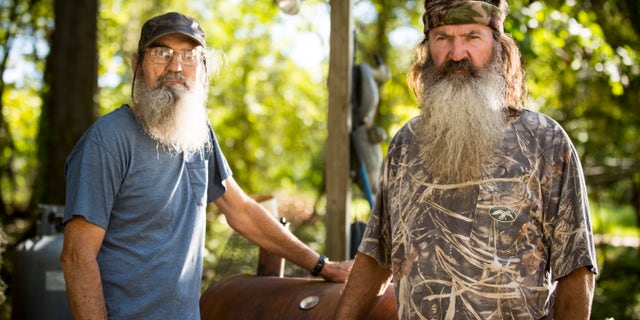 This undated image released by A&E shows brothers Silas "Uncle Si" Robertson, left, and Phil Robertson from the popular series "Duck Dynasty."
