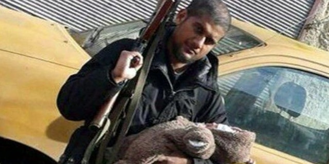 Siddhartha Dhar tweeted this photo of himself holding a rifle with his baby son.