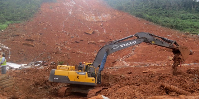 Heavy equipment is used as rescue workers search for survivors and victims following a mudslide in Regent, east of Freetown, Sierra Leone, Monday, Aug. 14, 2017.