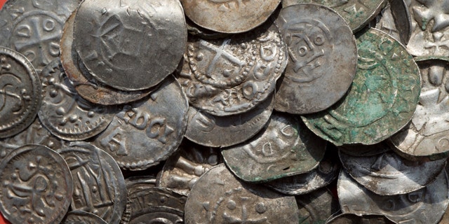 This April 13, 2018 photo shows medieval Saxonian, Ottoman, Danish and Byzantine coins found near Schaprode on the northern German island of Ruegen in the Baltic Sea. (Stefan Sauer/dpa via AP)