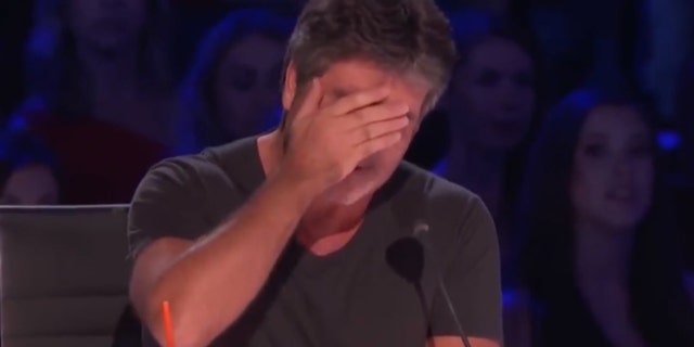 Simon Cowell attempts to hide his tears after an emotional performance from a contestant on "America's Got Talent."