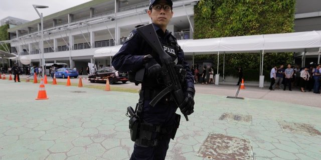 A police officer guards the entrance of the international media center in Singapore ahead of the June 12 summit between U.S. President Donald Trump and North Korean leader Kim Jong Un, June 10, 2018.