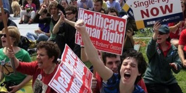 Kelly McNayr, center, of Burlington, Vt. , shouts with the crowd during a health care rally Saturday, May 1, 2010, at the statehouse in Montpelier, Vt. , where several hundred single-payer health care system supporters gathered believing that the federal bill didn't go far enough. (AP)