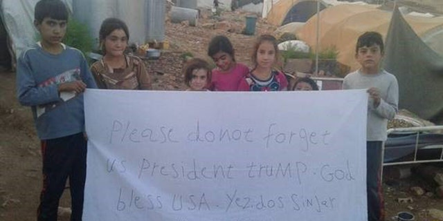 Yazidi Children at a camp in Mt. Sinjar also made signs with a direct message to the President.