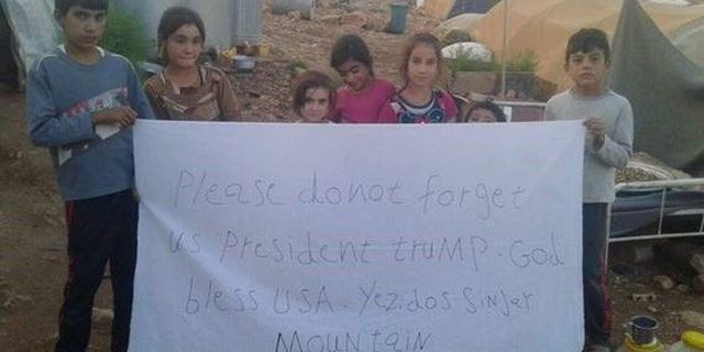 Yazidi Children at a camp in Mt. Sinjar also made signs with a direct message to the President.