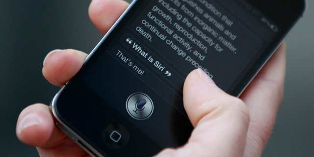 Luke Peters demonstrates Siri, an application which uses voice recognition and detection on the iPhone 4S, outside the Apple store in Covent Garden, London October 14, 2011. REUTERS/Suzanne Plunkett (BRITAIN - Tags: BUSINESS SOCIETY SCIENCE TECHNOLOGY TELECOMS) - RTR2SNOL