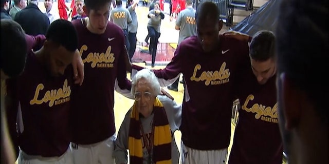Sister Jean prays with the team before every game.