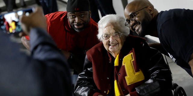 Sister Jean Dolores Schmidt, 98, the team chaplain for Loyola-Chicago, poses for a photo with fans at an NCAA men's basketball tournament game in Atlanta, March 24, 2018.