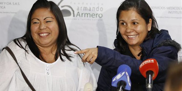 Feb. 25, 2016: Jacqueline Vasquez Sanchez, left, and her sister Lorena Sanchez, right, smile during a press conference in Bogota, Colombia.