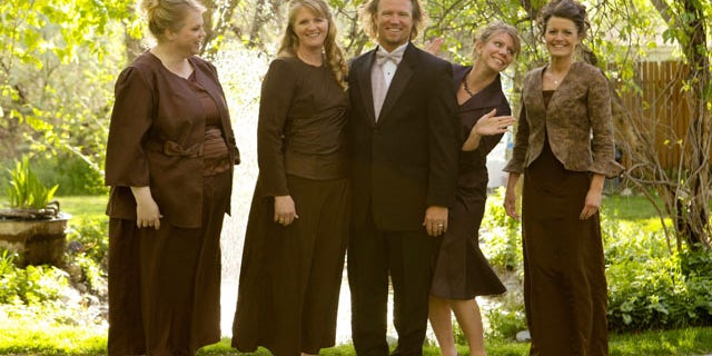 In this publicity image released by TLC, the Browns, from left, Janelle, Christine, Kody, Meri, and Robyn from the TLC series,"Sister Wives," are shown.