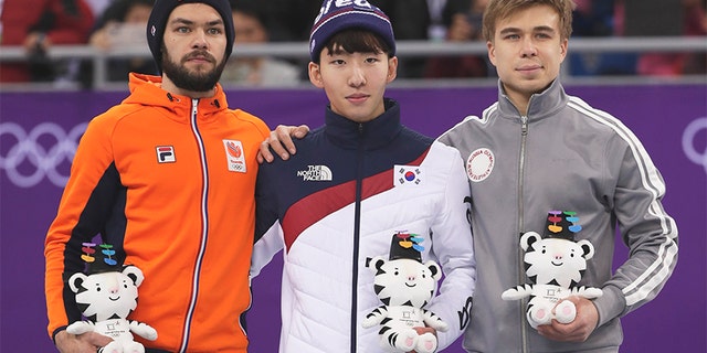 Feb. 10, 2018: Lim Hyojun, center, of South Korea stands on a podium during a Venue Ceremony following his win in the men's 1500 meters short-track speedskating final in the Gangneung Ice Arena at the 2018 Winter Olympics.