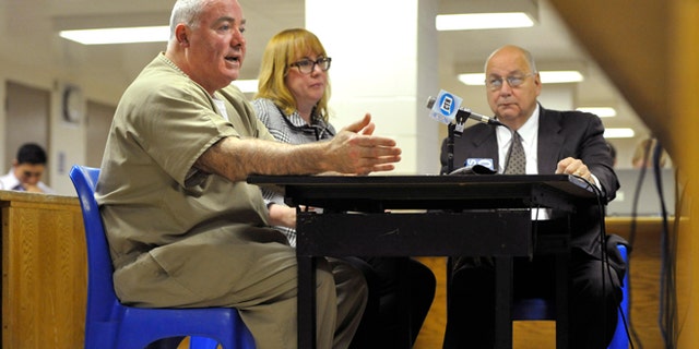 Oct. 24, 2012: Michael Skakel, left, addresses a parole board with his attorneys Hope Seeley, center, and Hubert Santos, right, at his side during a parole hearing at McDougall-Walker Correctional Institution in Suffield, Conn.