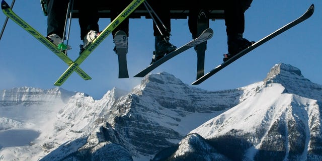 Skiers ride the lift in Lake Louise, Alberta November 30, 2003. (REUTERS/AndyClarkAC/HB)