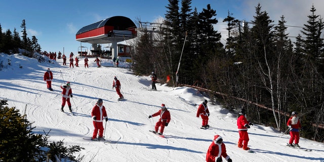 Skiers dressed as Santa Claus ski en masse in Maine.