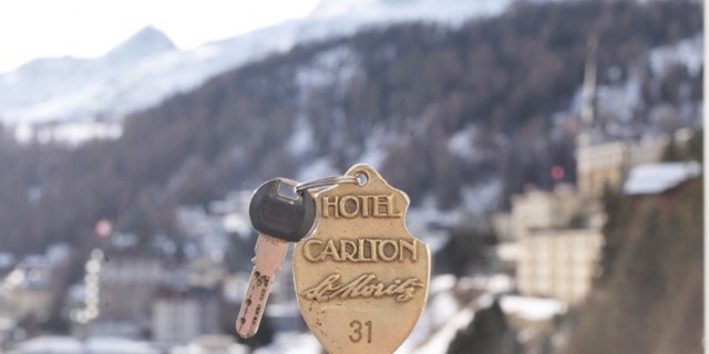 An electronic key with an old fashioned brass fob.