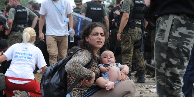 Macedonian volunteers and police with refugees in Gevgelija, near the border of Macedonia and Greece. (FoxNews.com)