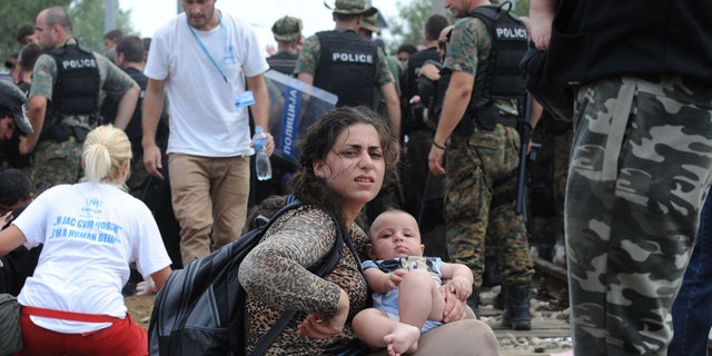 Macedonian volunteers and police with refugees in Gevgelija, near the border of Macedonia and Greece. (FoxNews.com)