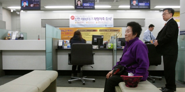 March 20, 2013: A customer sits in a branch of Shinhan Bank in Seoul, South Korea, while the bank's computer networks are paralyzed.