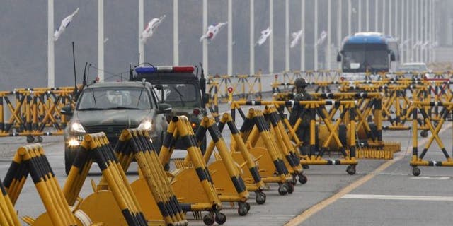 April 6, 2013: South Korean army vehicles cross Unification Bridge in Paju, South Korea, near the border village of Panmunjom.